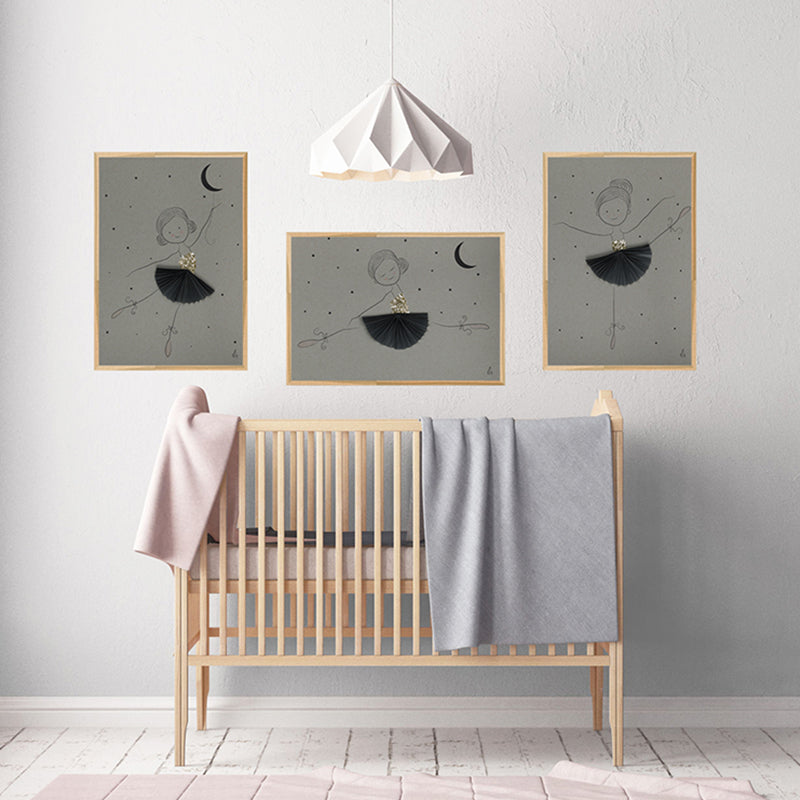 Nursery room with wooden crib, gray blanket, and framed wall art on a light gray wall.