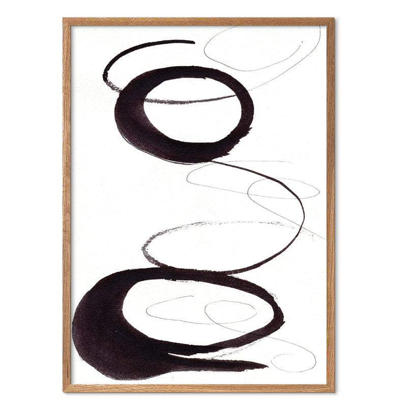Abstract art print with black and white brush strokes in a wooden frame on a white background