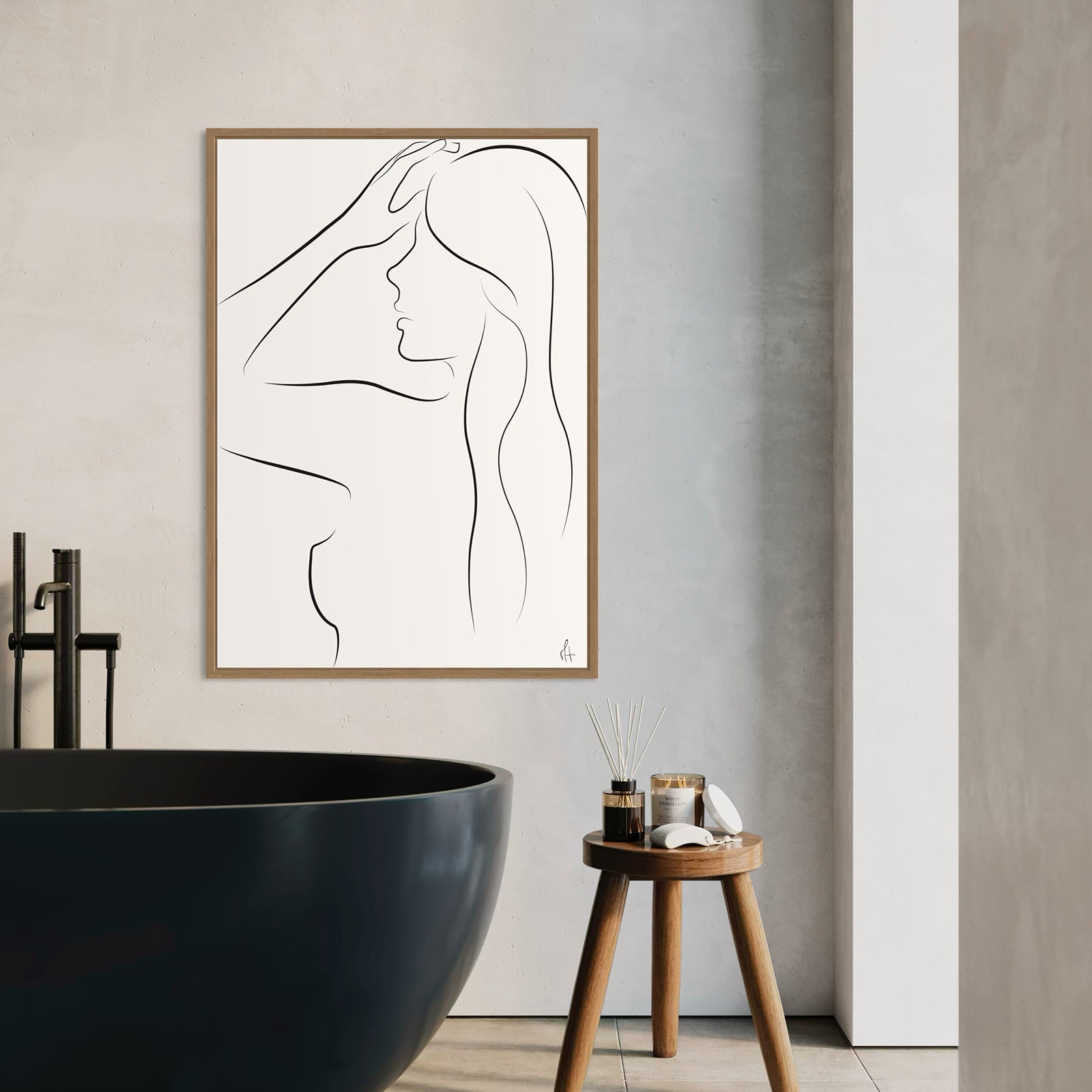 Minimalist line art of a woman's profile in a wooden frame on a bathroom wall.